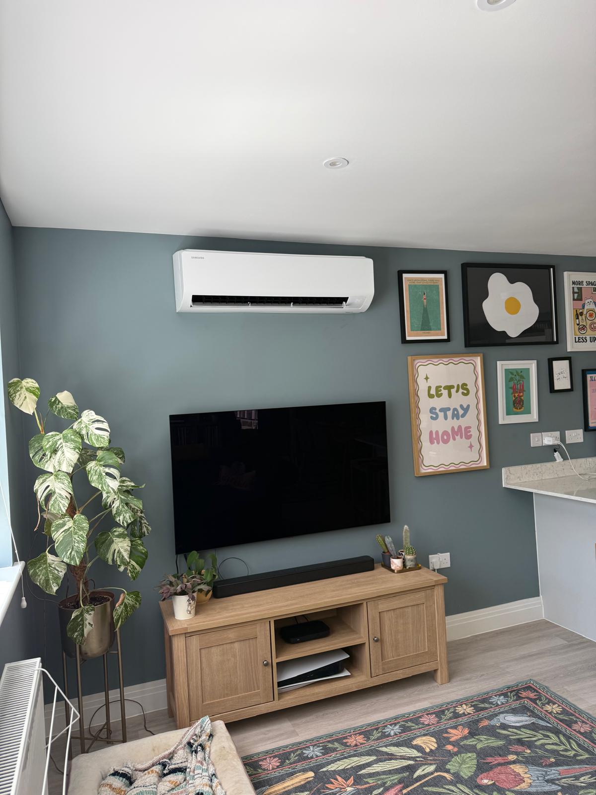 White Samsung wall-mounted air conditioning unit in a modern living room