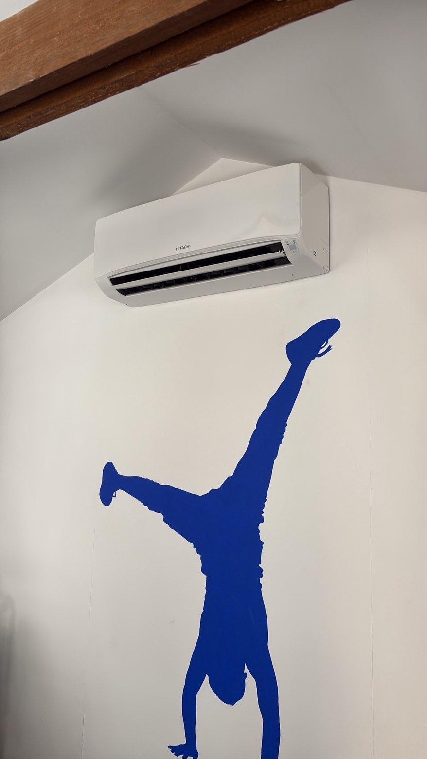 White Hitachi wall-mounted air conditioning unit