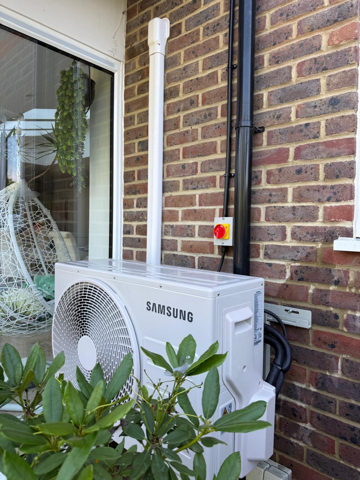 Samsung outdoor air conditioning unit installed beside a patio door